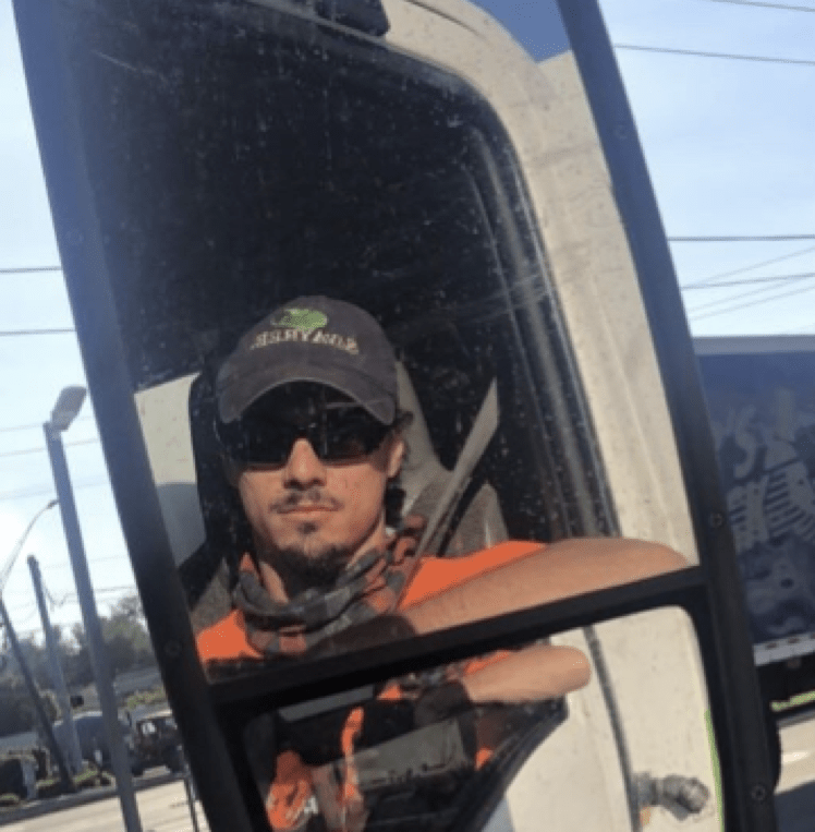 John looking in truck mirror reflection