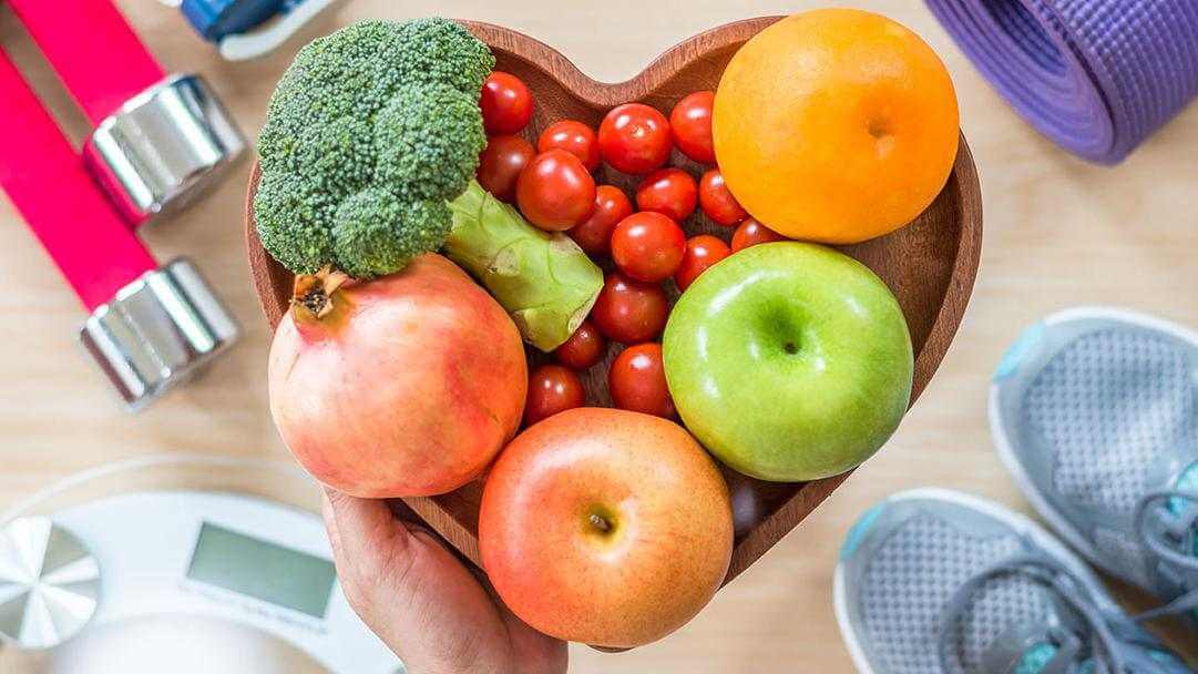 Fruit and vegetables in heart shaped bowl