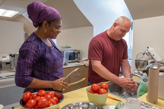 Couple washing tomatoes