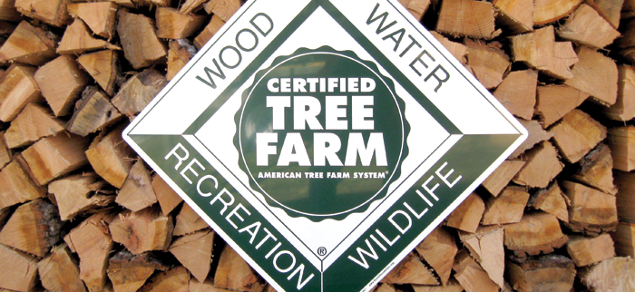American Tree Farm System logo against a backdrop of cut firewood logs