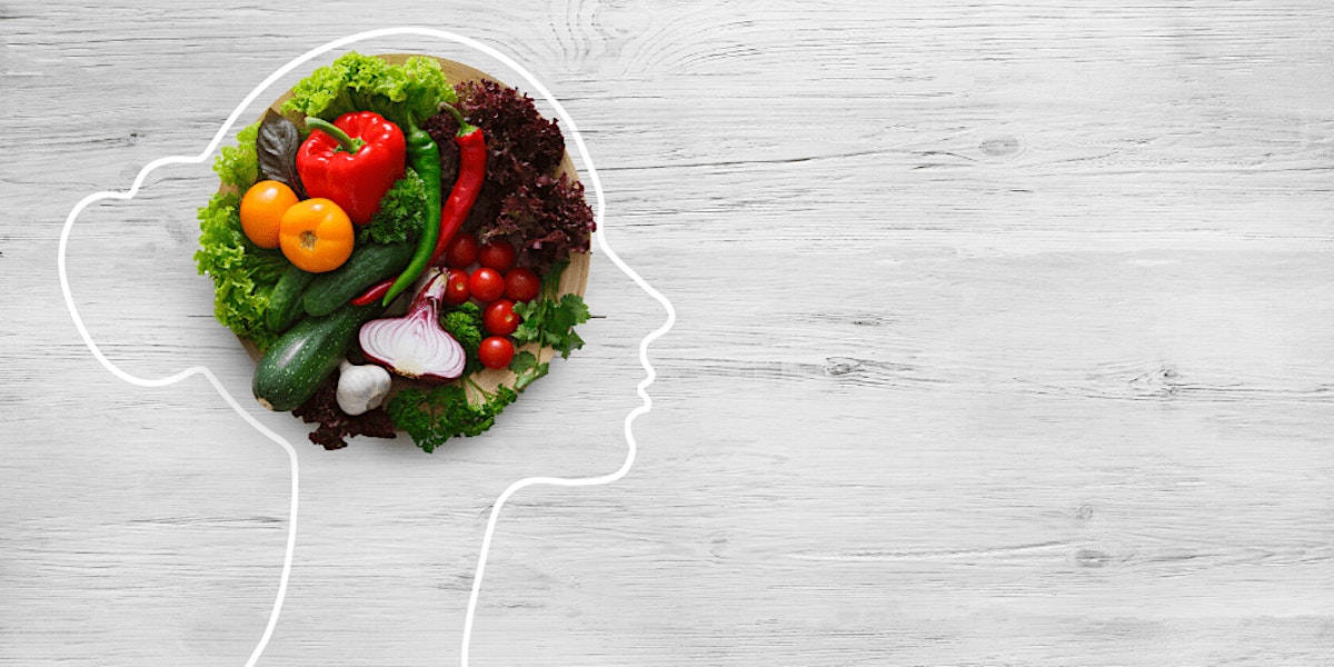 outline of a person's head with a plateful of vegetables where the brain is located.