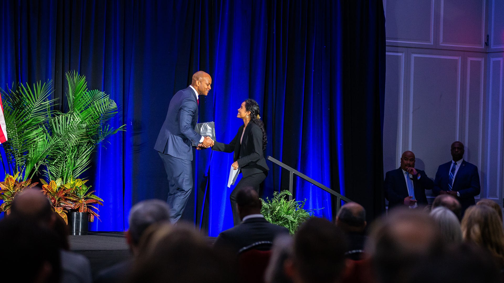 Maryland Gov. Wes Moore shakes hands with student speaker Anushka Tandon, an environmental science and technology major, at the event.