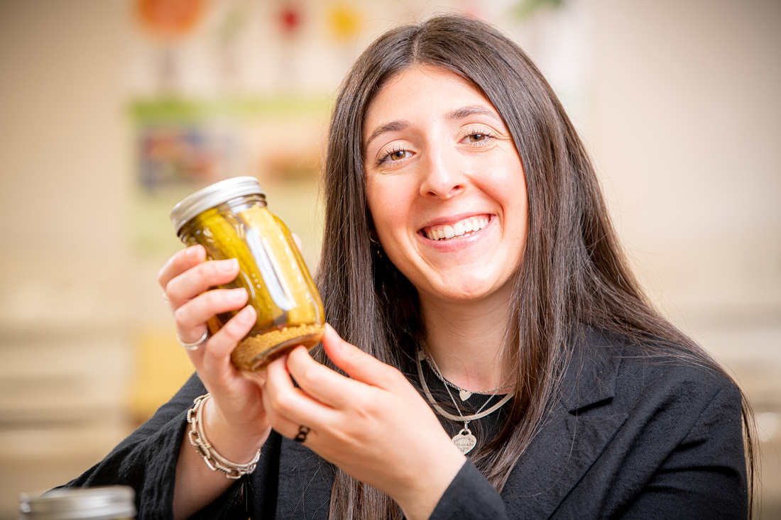 Student with a jar of pickles
