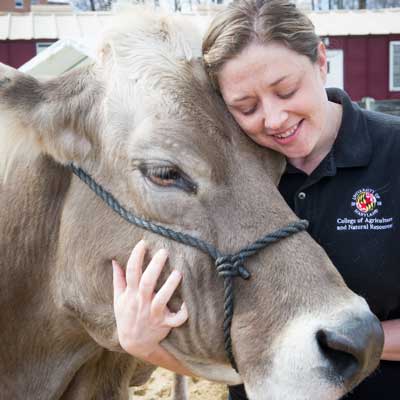 Woman hugging cow head