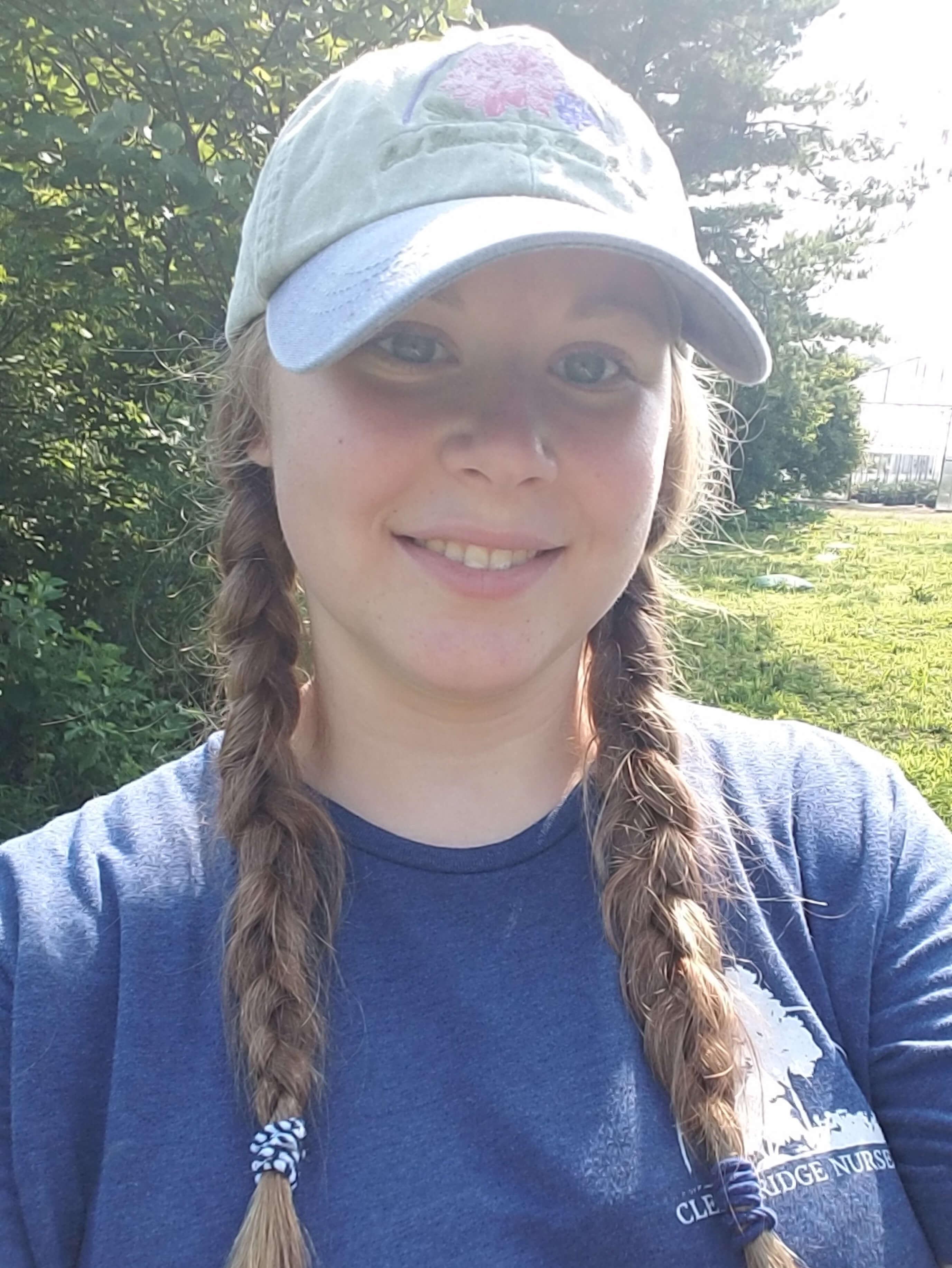 Alum Lydia Printz selfie with baseball hat and blue shirt