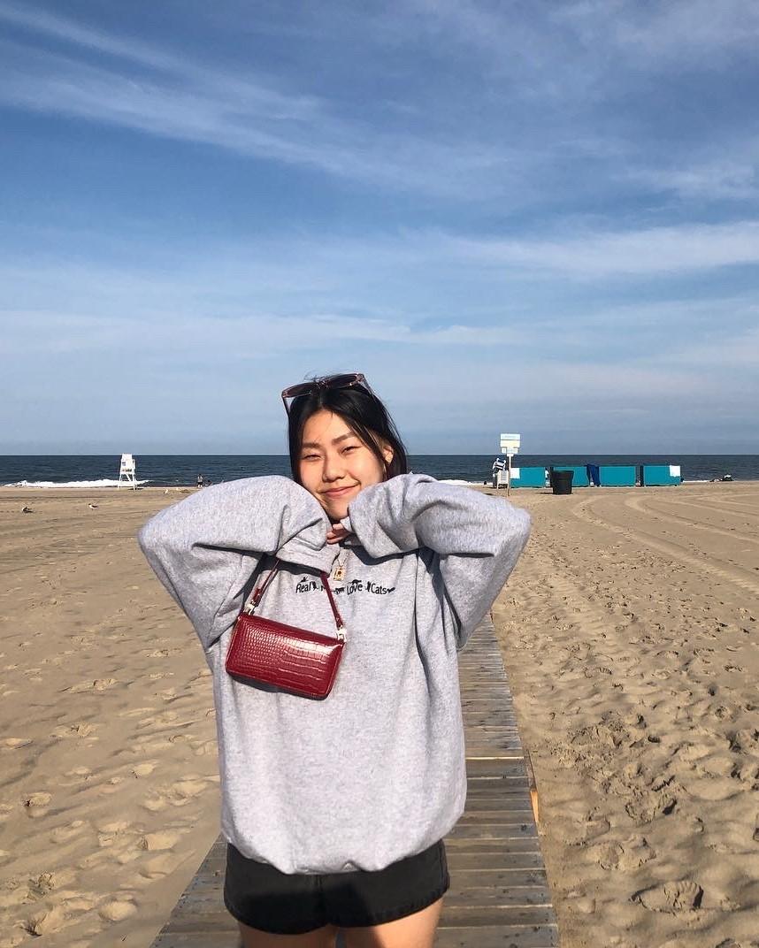 Jimin Lee. Student posing happily on a beach.