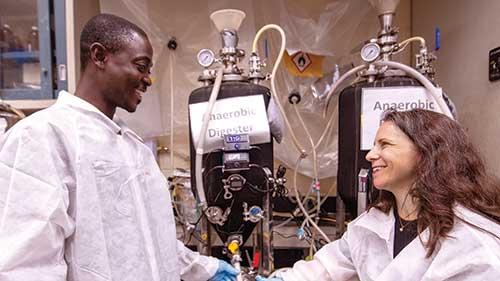 Adanyro Atilago with Stephanie Lansing in a lab