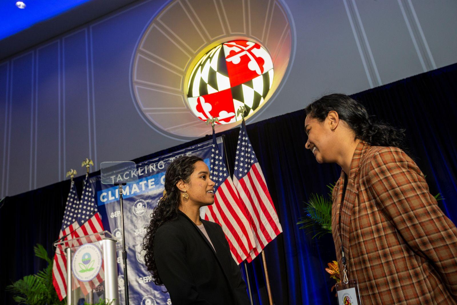Student at an event talking with an attendee