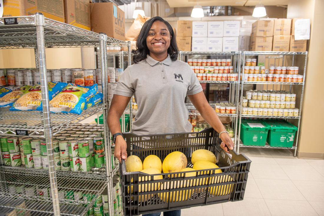 Student holding up food in the Campus Pantry