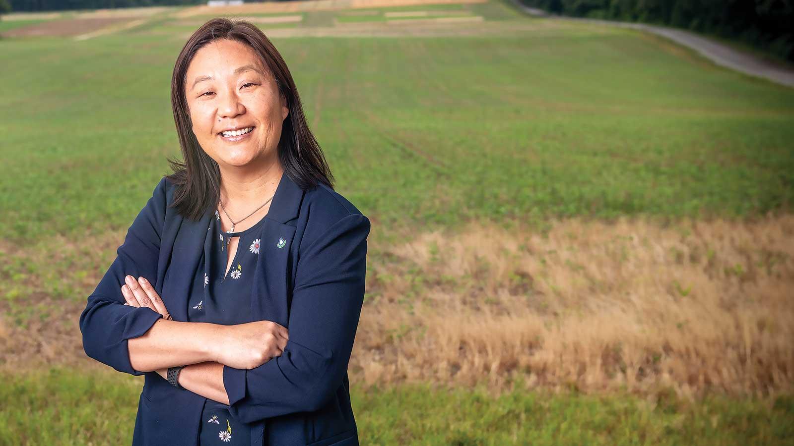 Suzy Daubert standing in front of a field