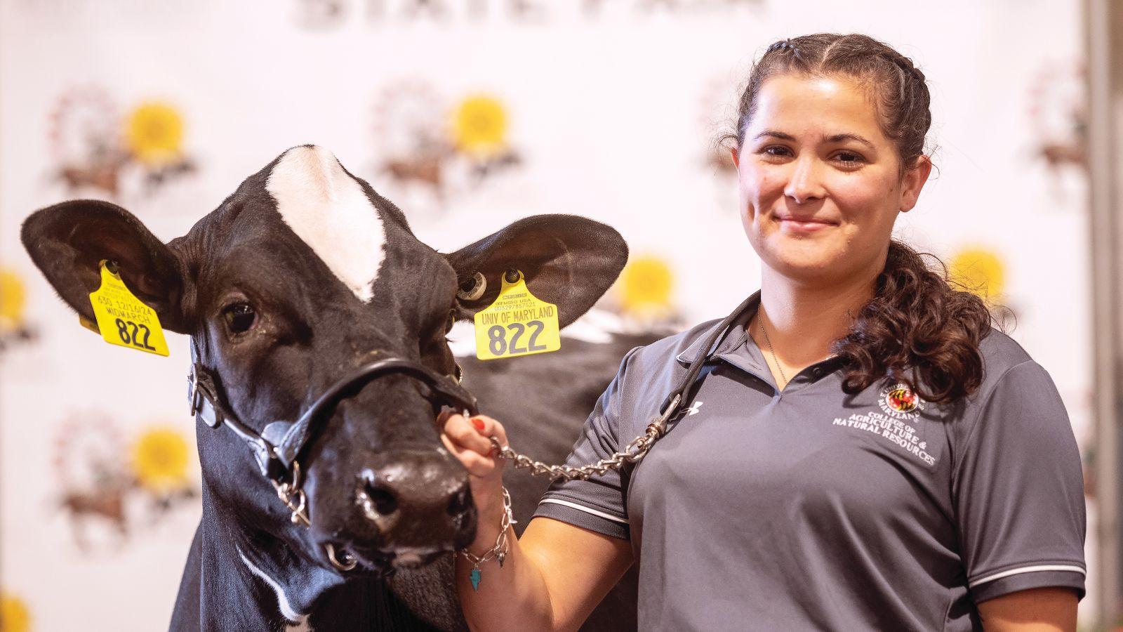 Raven Herron standing with a cow at Maryland State Fair