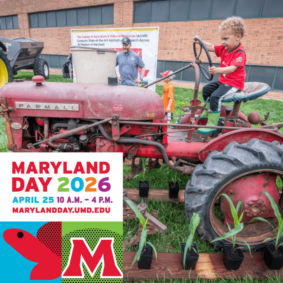 Kid standing on a tractor at Maryland Day with an employee looking on