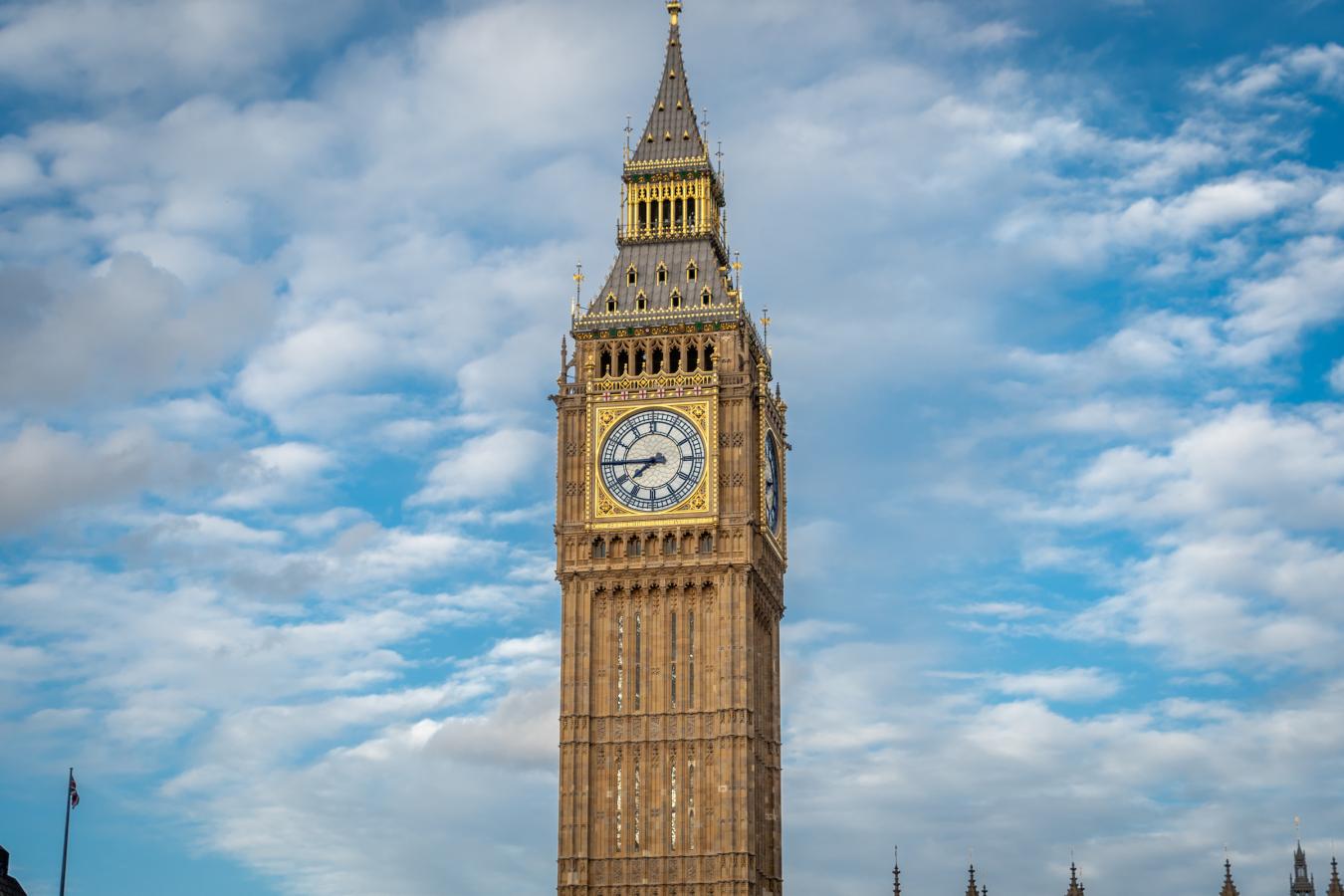 Photo of Big Ben with a blue cloudy sky behind it 