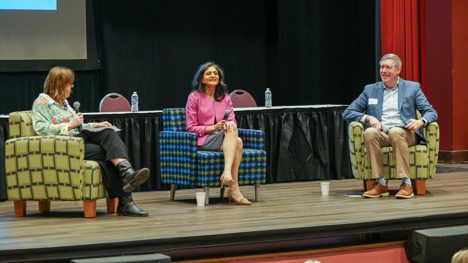 Speakers on stage during a panel discussion.