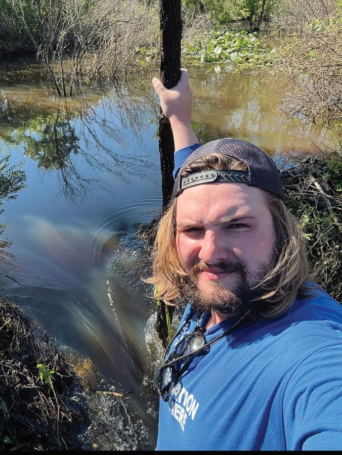 Thomas Rhoades in a marsh